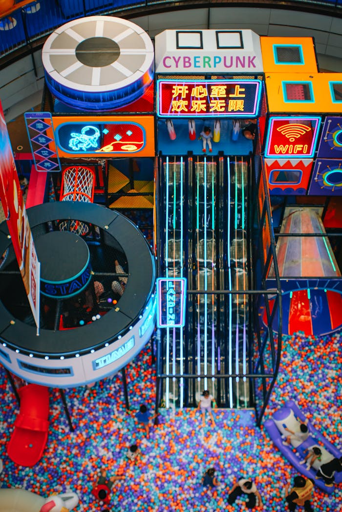 Colorful indoor playground featuring futuristic cyberpunk design and ball pit.
