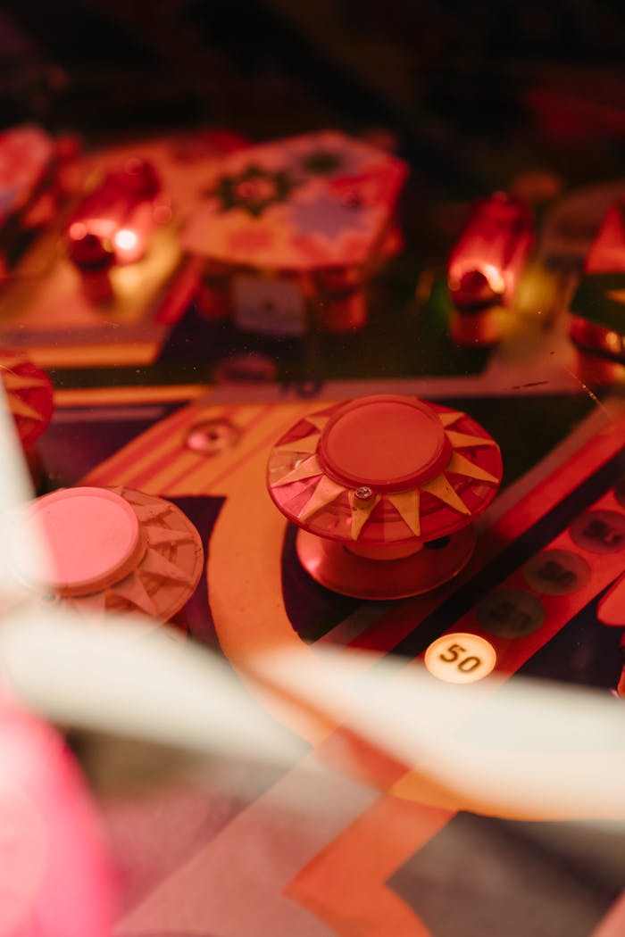 services-02 Colorful vintage pinball machine with illuminated bumpers and intricate details.